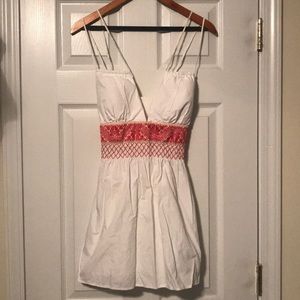 Very pretty white top with red detailed waist.